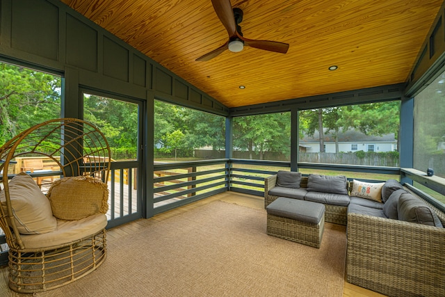 sunroom / solarium with wooden ceiling, ceiling fan, and vaulted ceiling