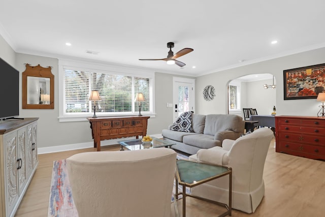 living room featuring ceiling fan, light hardwood / wood-style floors, and ornamental molding