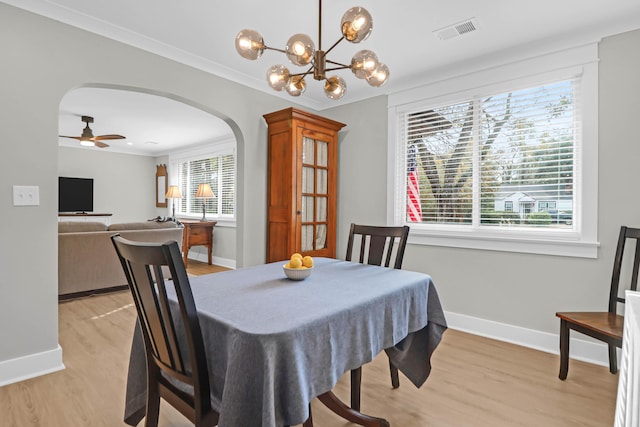 dining room featuring plenty of natural light, ceiling fan with notable chandelier, and light hardwood / wood-style flooring