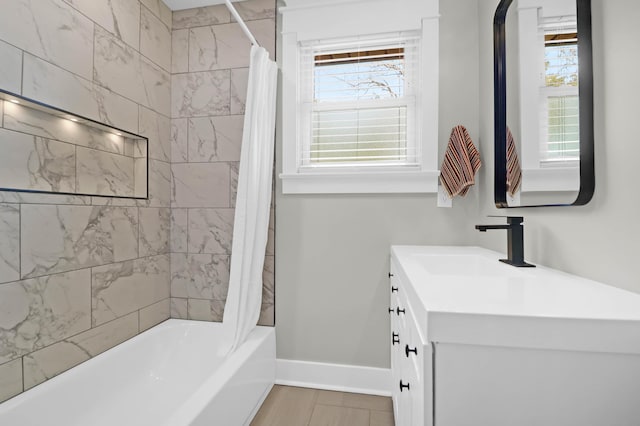 bathroom featuring shower / bath combo with shower curtain and vanity