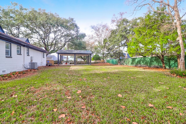 view of yard featuring a gazebo and central AC