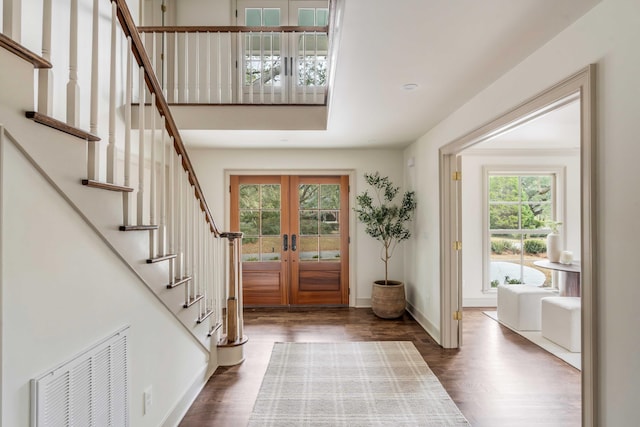 foyer with french doors and dark hardwood / wood-style flooring