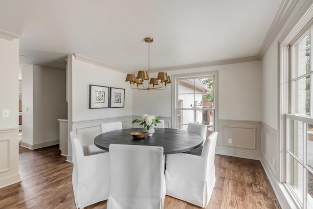 dining space with a notable chandelier, dark hardwood / wood-style floors, crown molding, and a wealth of natural light