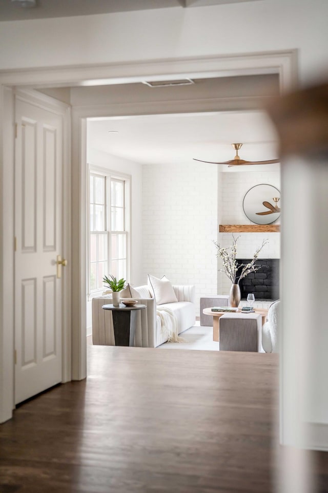 interior space featuring dark hardwood / wood-style flooring and brick wall