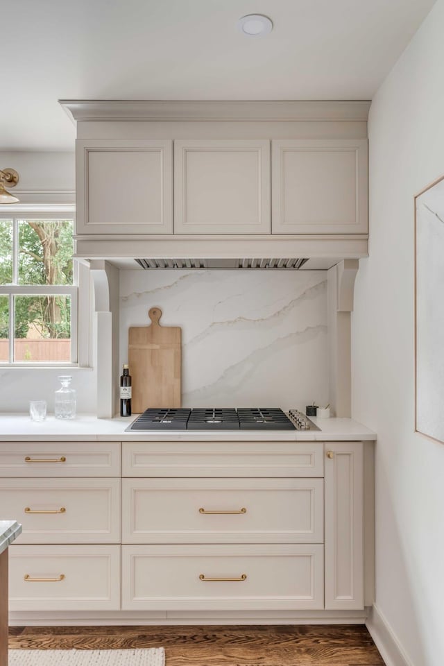 interior space featuring white cabinets, stainless steel gas stovetop, and wood-type flooring