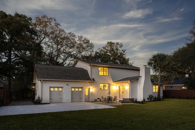 view of front of home featuring a garage, a patio, and a front yard