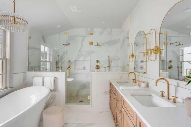 bathroom with vanity, independent shower and bath, tile walls, and a notable chandelier