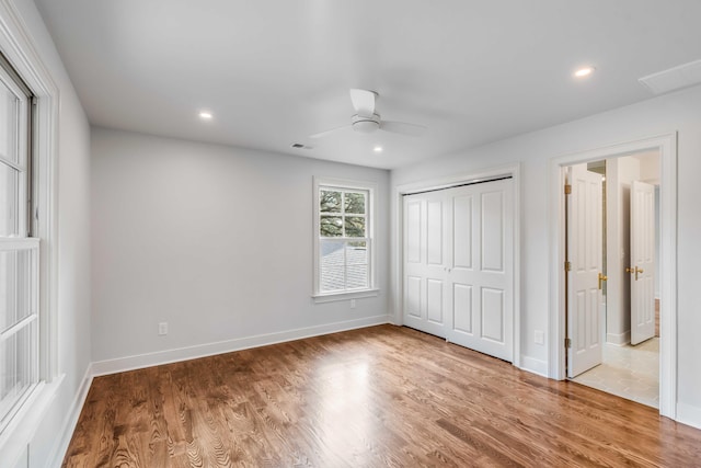 unfurnished bedroom with wood-type flooring, a closet, and ceiling fan