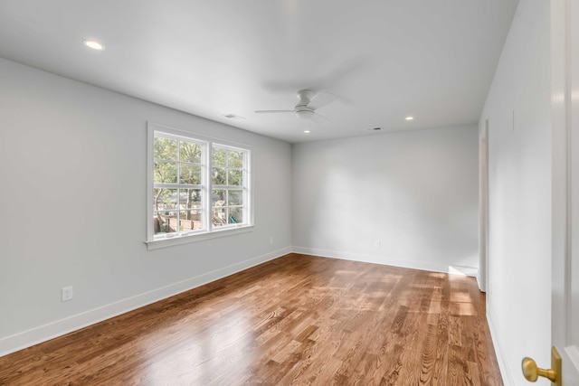 unfurnished room with ceiling fan and hardwood / wood-style floors