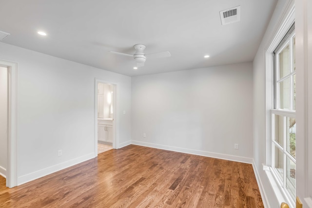 spare room with hardwood / wood-style floors and ceiling fan