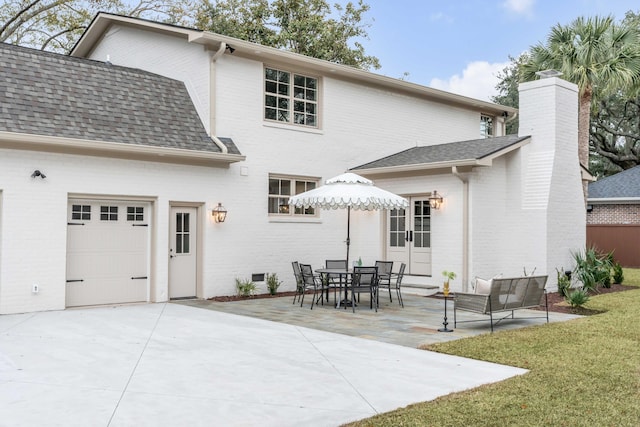 back of house featuring a patio area and a garage