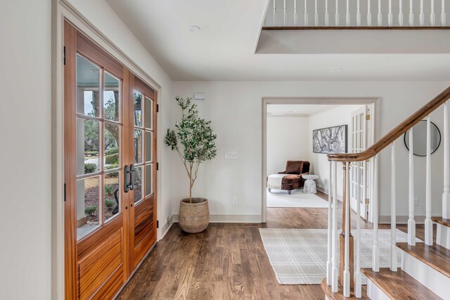 foyer entrance with dark wood-type flooring and french doors