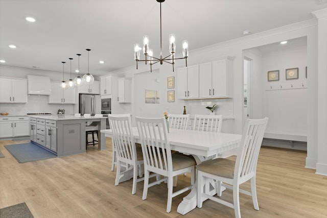 dining room with ornamental molding, recessed lighting, a chandelier, and light wood-style flooring