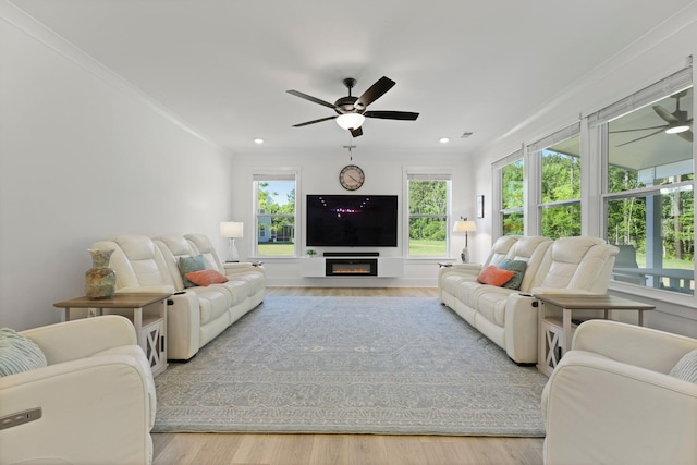 living room with ceiling fan, wood finished floors, recessed lighting, and ornamental molding
