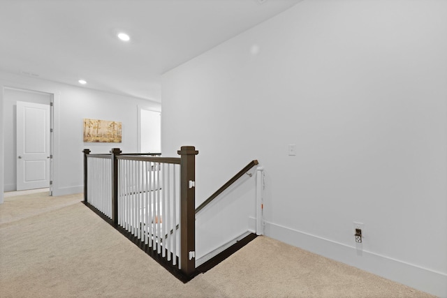 corridor featuring an upstairs landing, carpet flooring, recessed lighting, and baseboards