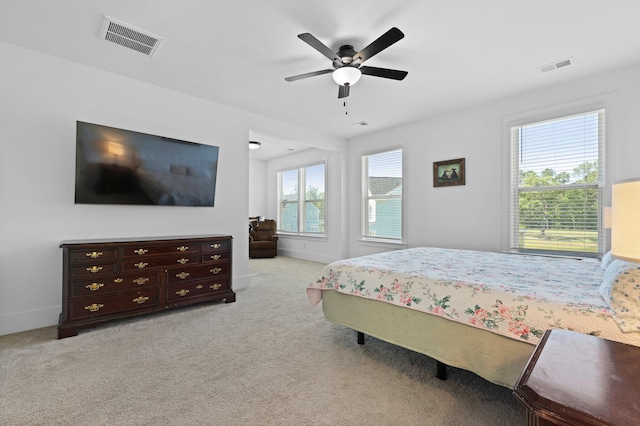 bedroom with light carpet, ceiling fan, and baseboards