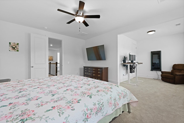 bedroom featuring light colored carpet, a ceiling fan, and baseboards