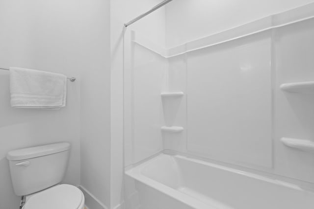 full bath featuring baseboards and toilet
