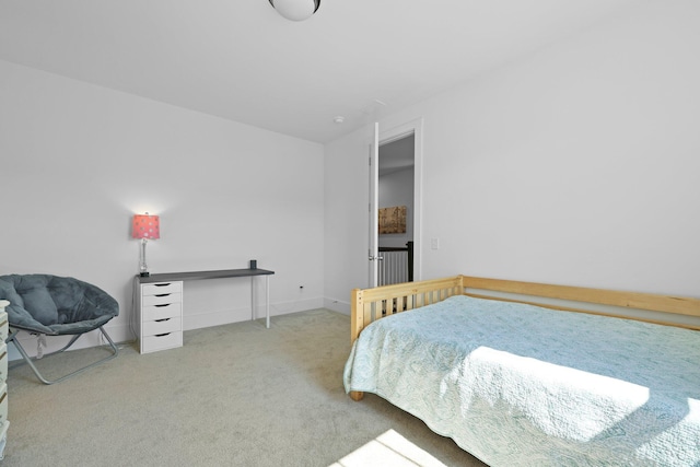 carpeted bedroom featuring baseboards