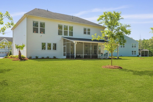 rear view of house with a sunroom and a lawn