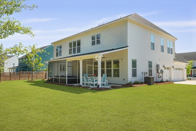 rear view of house with concrete driveway, a sunroom, and central air condition unit
