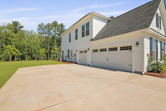 view of property exterior with roof with shingles, a lawn, concrete driveway, and a garage