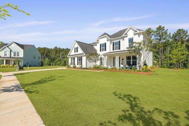 traditional-style home with covered porch and a front lawn