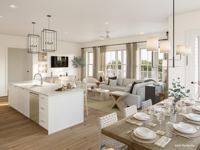 kitchen with light hardwood / wood-style flooring, an island with sink, sink, stainless steel dishwasher, and white cabinets