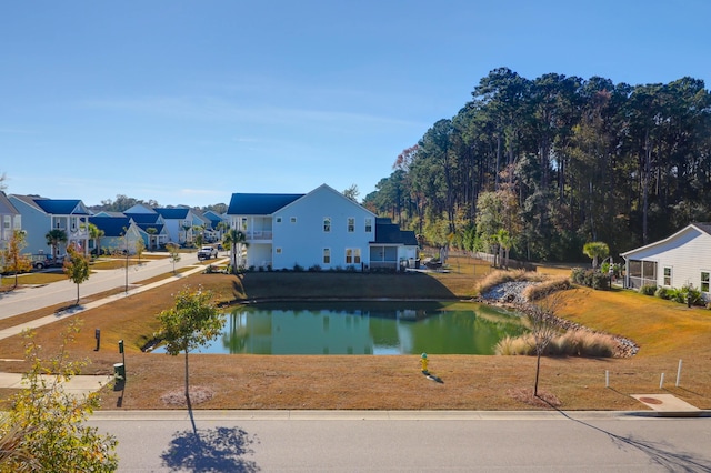 exterior space with a water view and a lawn