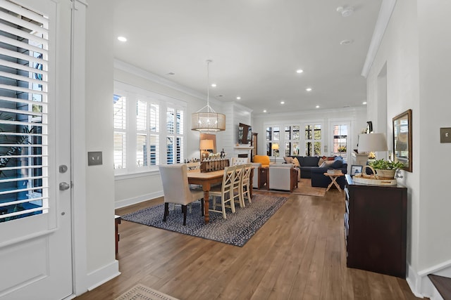 dining room with hardwood / wood-style flooring and ornamental molding