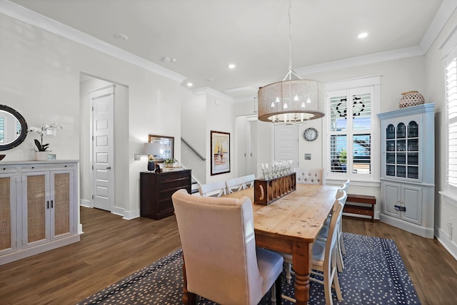 dining area with ornamental molding and dark hardwood / wood-style flooring