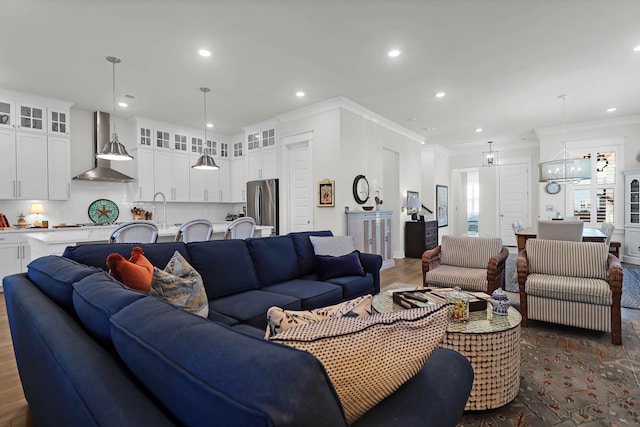 living room featuring dark hardwood / wood-style flooring, sink, crown molding, and a chandelier