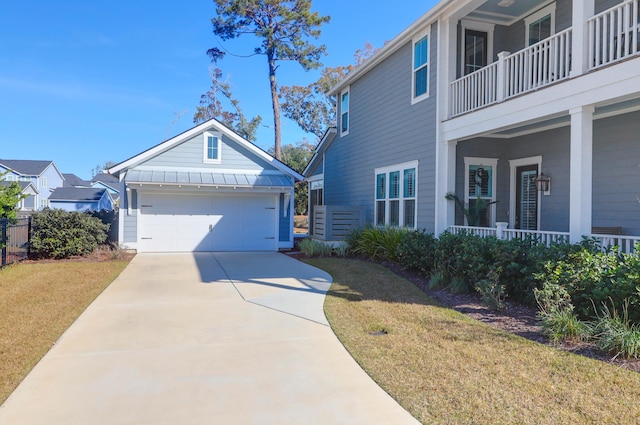 view of front of house with a garage, a balcony, and a front yard