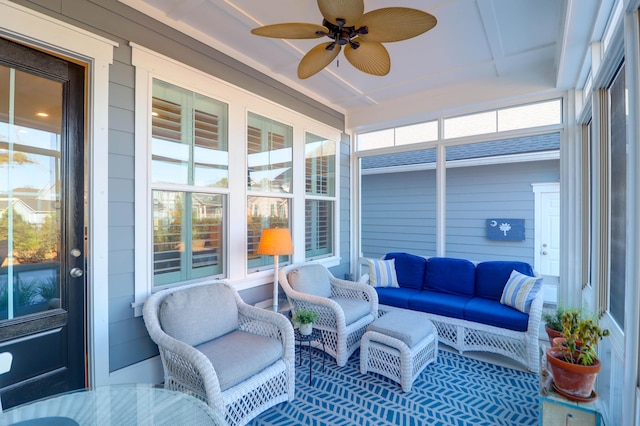 sunroom / solarium featuring ceiling fan