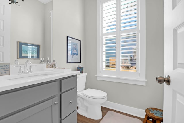 bathroom featuring vanity, hardwood / wood-style floors, and toilet