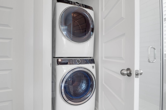 clothes washing area with stacked washer / drying machine