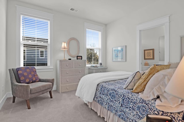 bedroom featuring light colored carpet