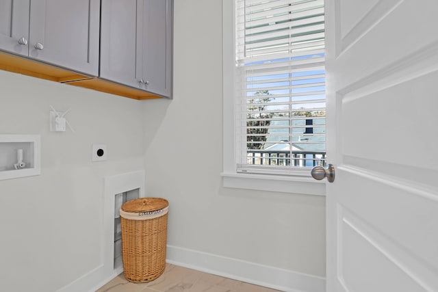 laundry room featuring cabinets, hookup for a washing machine, and electric dryer hookup