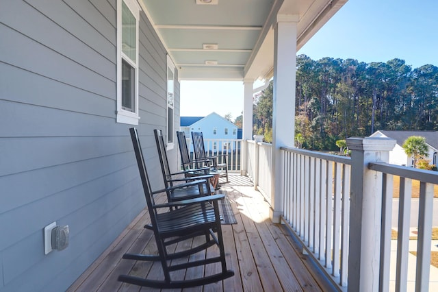 wooden terrace featuring covered porch