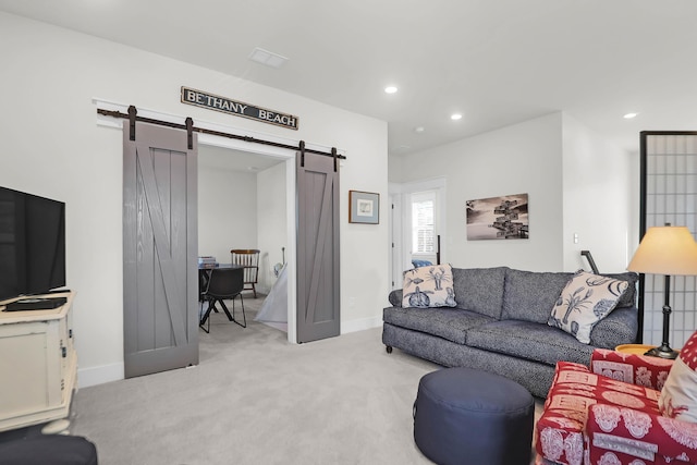 carpeted living room with a barn door