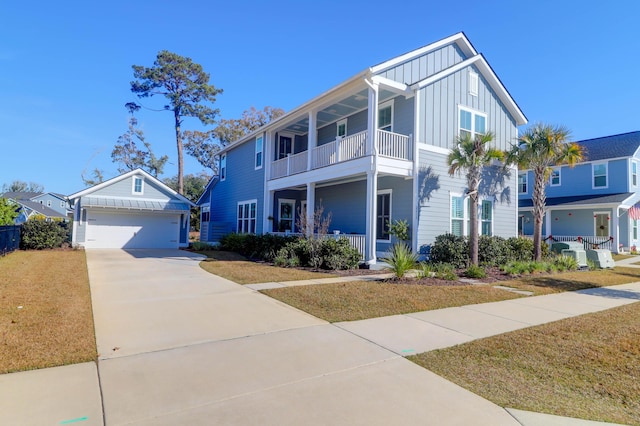 view of front of house with a garage, a front yard, and a balcony