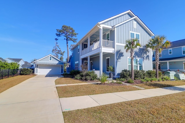 view of front of property with a garage, a front lawn, and a balcony