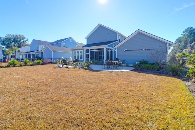 back of property featuring a patio, a sunroom, and a yard