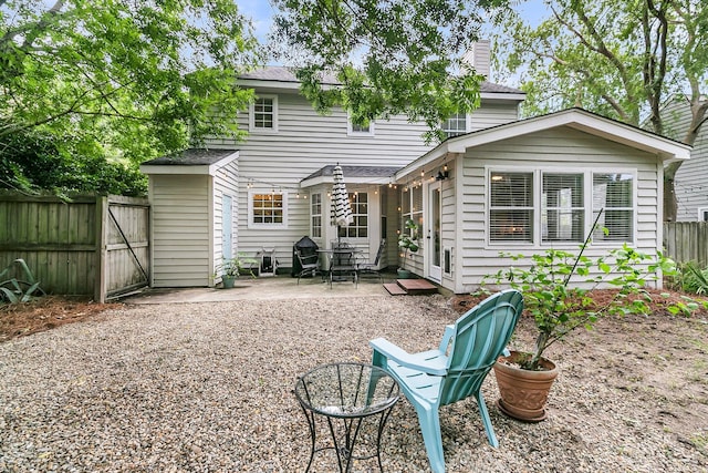 1433 Oaklanding Rd, Mount Pleasant, SC 29464 - rear view of house featuring a patio area, a chimney, a shingled roof, and a gate