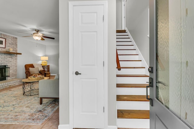 1433 Oaklanding Rd, Mount Pleasant, SC 29464 - staircase featuring ceiling fan, a fireplace, and tile patterned flooring