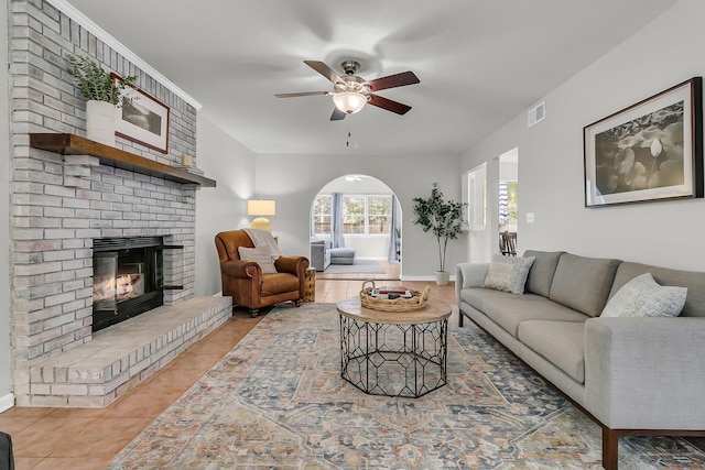 1433 Oaklanding Rd, Mount Pleasant, SC 29464 - living area with light tile patterned flooring, a ceiling fan, arched walkways, and a brick fireplace