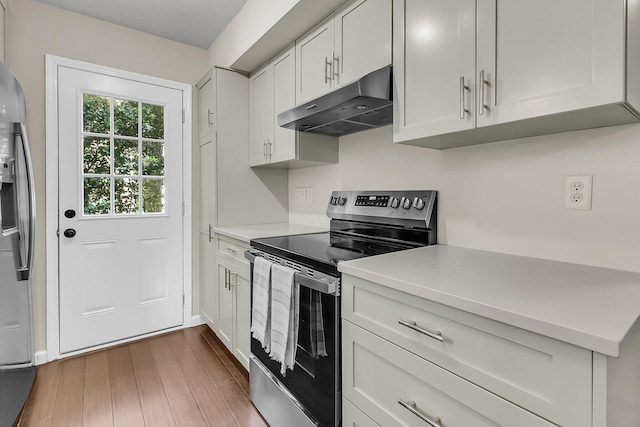 1433 Oaklanding Rd, Mount Pleasant, SC 29464 - kitchen featuring appliances with stainless steel finishes, under cabinet range hood, light countertops, and dark wood-style floors