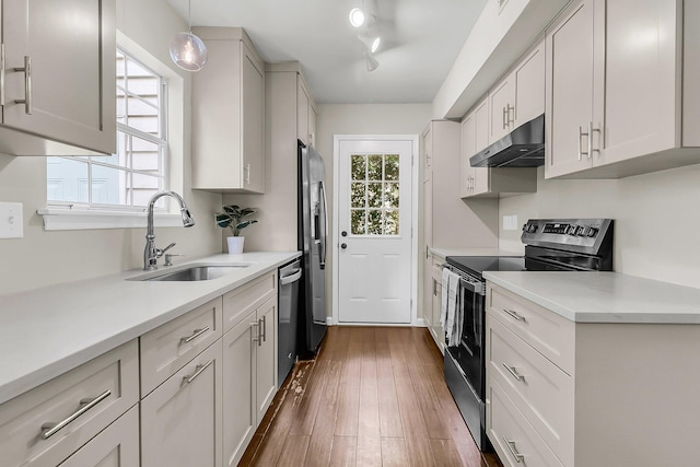 1433 Oaklanding Rd, Mount Pleasant, SC 29464 - kitchen with stainless steel appliances, under cabinet range hood, light countertops, and dark wood finished floors