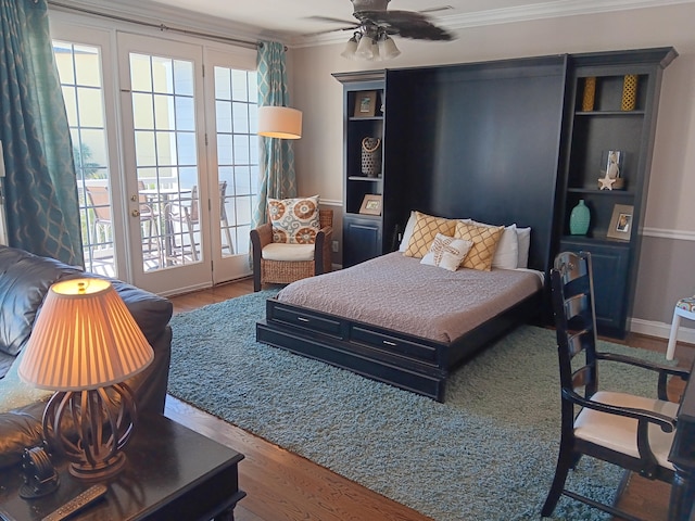 bedroom with ceiling fan, ornamental molding, access to outside, and wood-type flooring