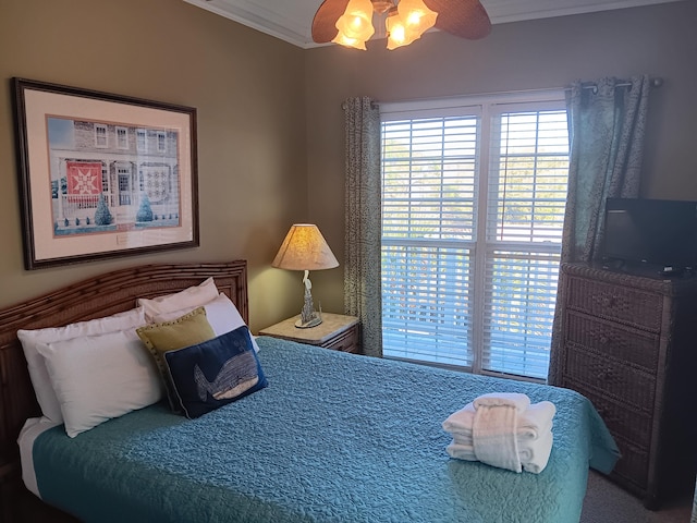 carpeted bedroom with ceiling fan and ornamental molding